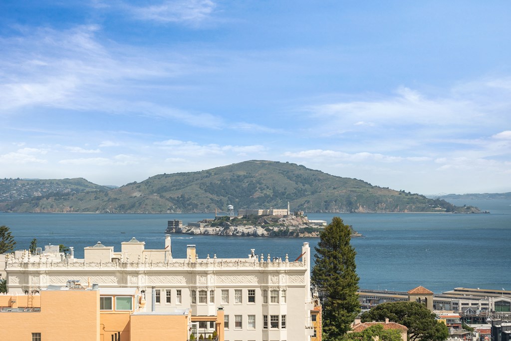 a view of the city and the ocean and a mountain in the