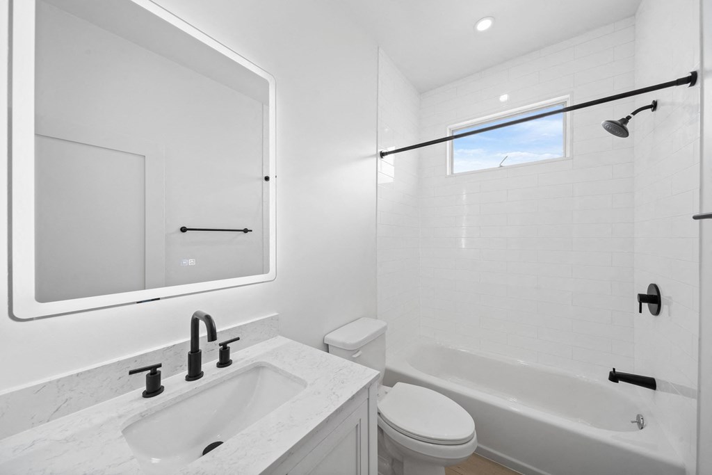 a bathroom with a sink toilet and a bath tub