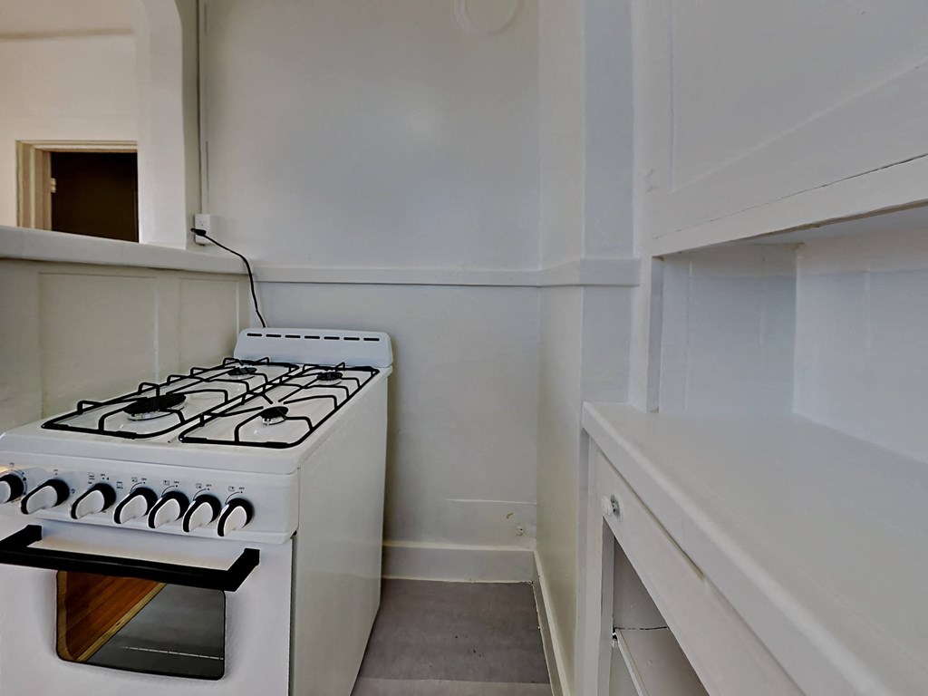 a small kitchen with a stove and a counter