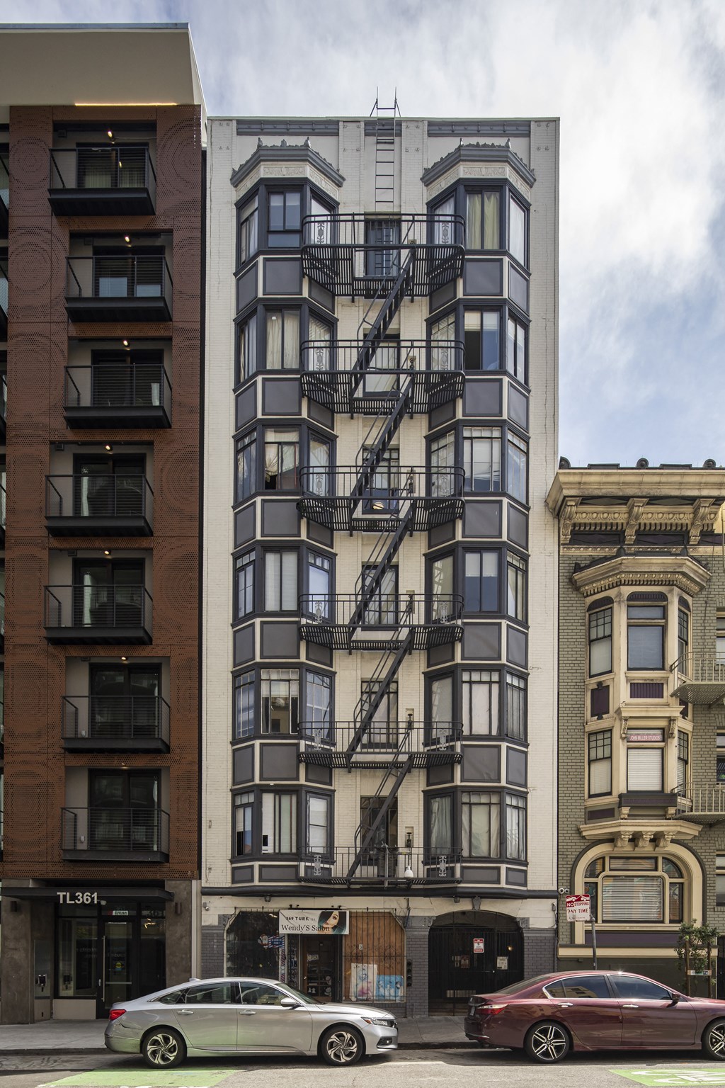 a tall apartment building with a fire escape on the side of it