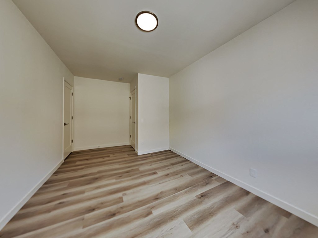 a living room with wood floors and white walls