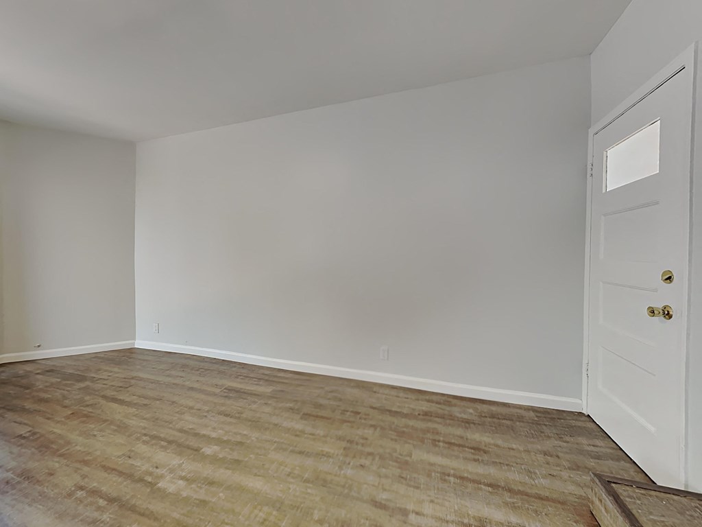 an empty room with white walls and a door