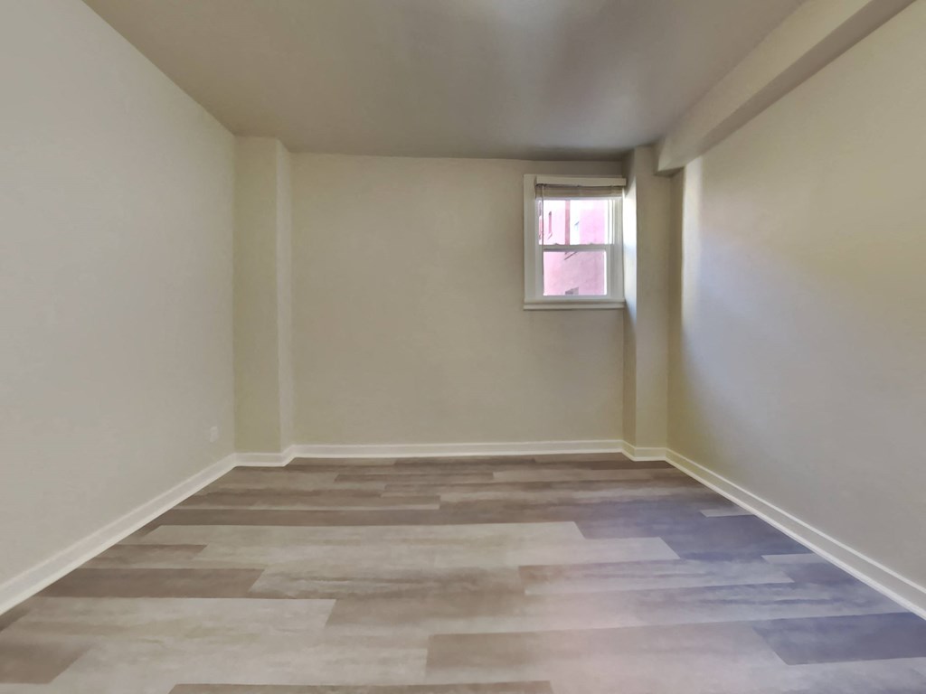 a empty room with a window and a tiled floor