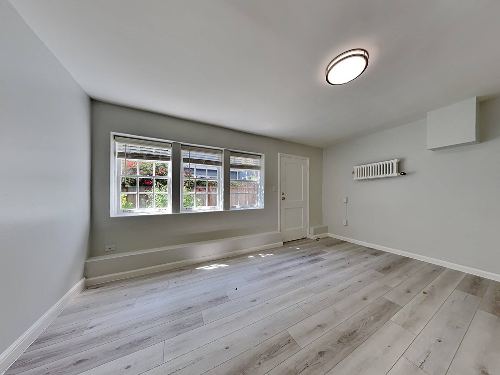 an empty room with white walls and a window