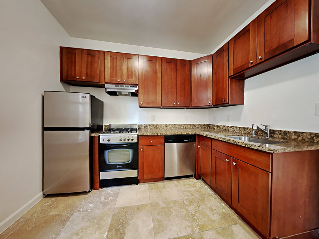 a kitchen with stainless steel appliances and wooden cabinets