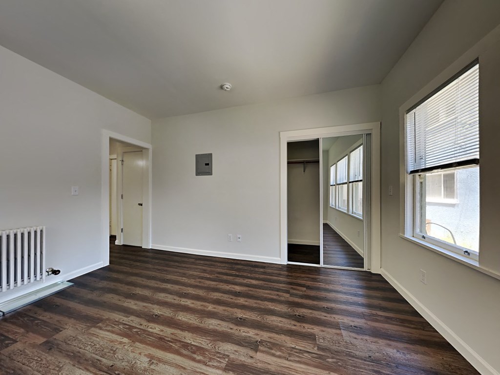 a living room with a hard wood floor and a large window