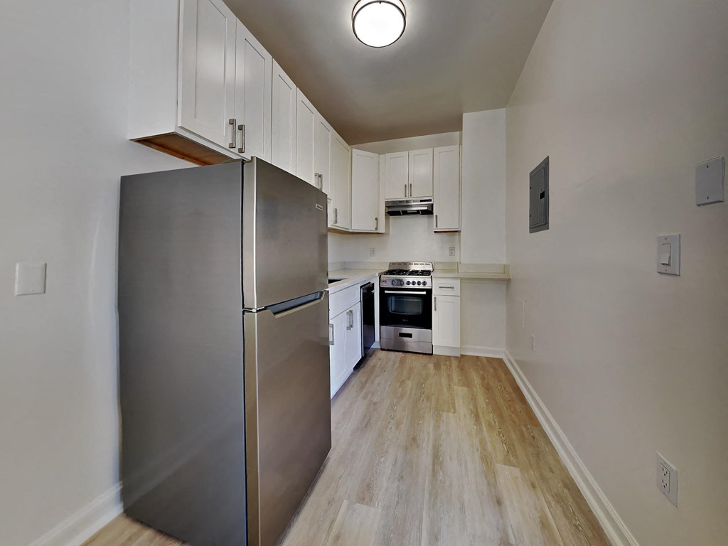 a kitchen with stainless steel appliances and white cabinets
