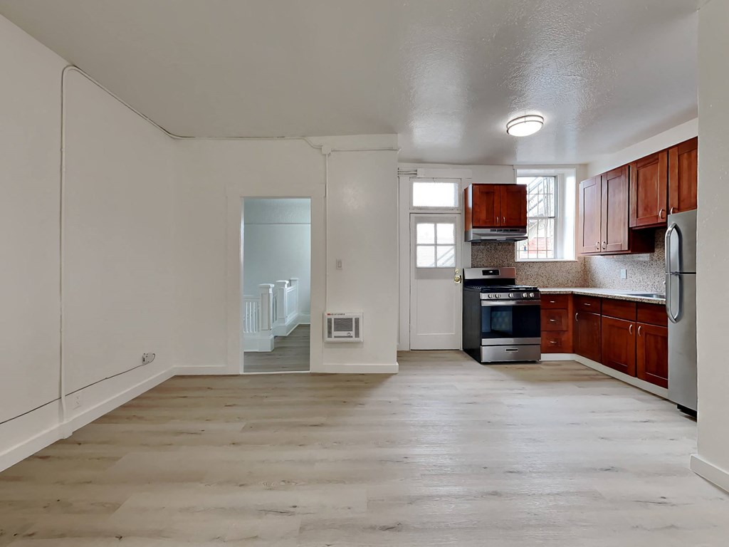 a kitchen with wooden cabinets and a stove and a refrigerator