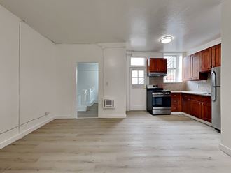 a kitchen with wooden cabinets and a stove and a refrigerator