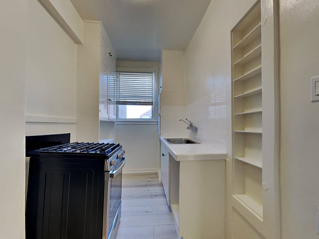 a small kitchen with a stove and a sink