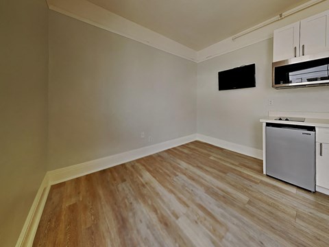 the living room of a home with a stove and a refrigerator