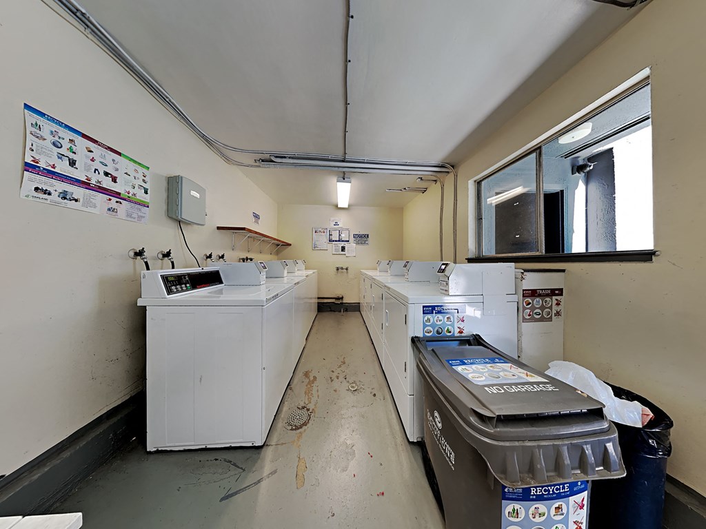 an empty laundry room with washing machines and other appliances