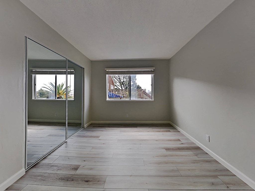 a living room with a large mirror and a window