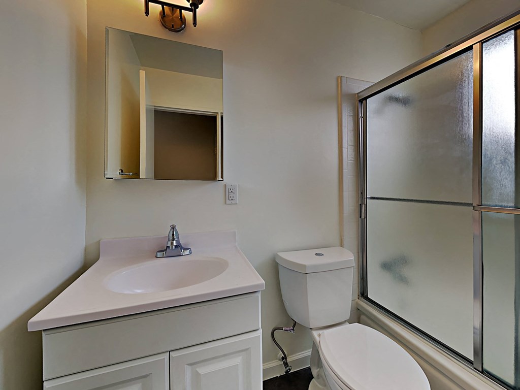 a bathroom with a sink toilet and a shower