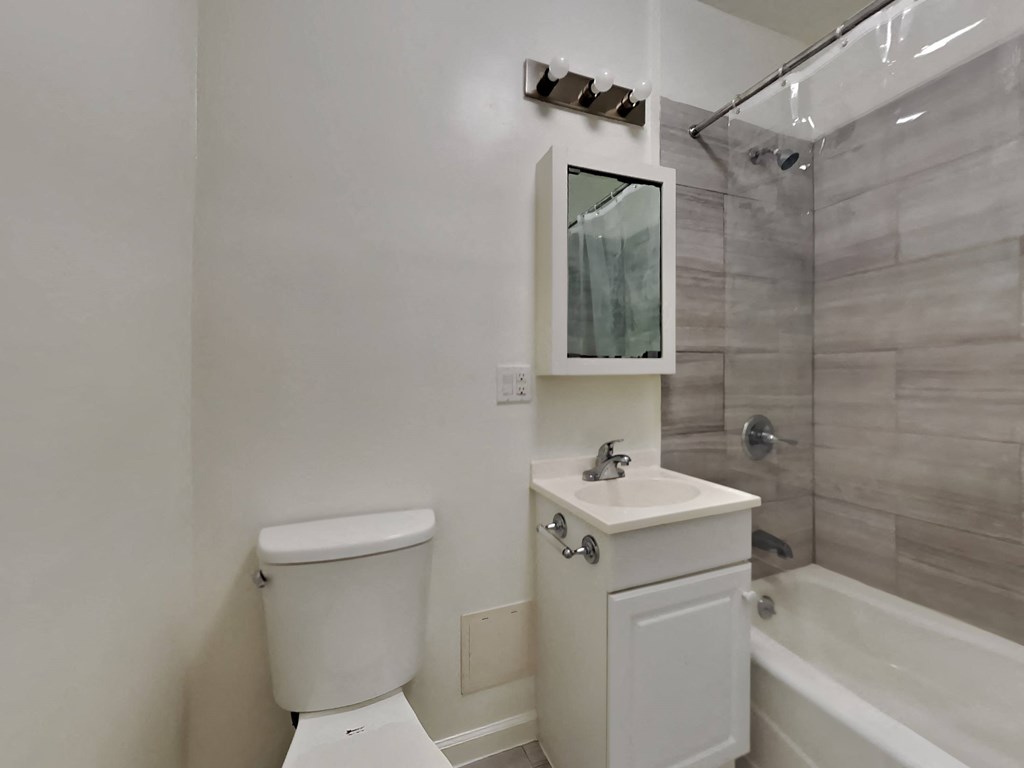 a bathroom with a toilet and a sink and a shower