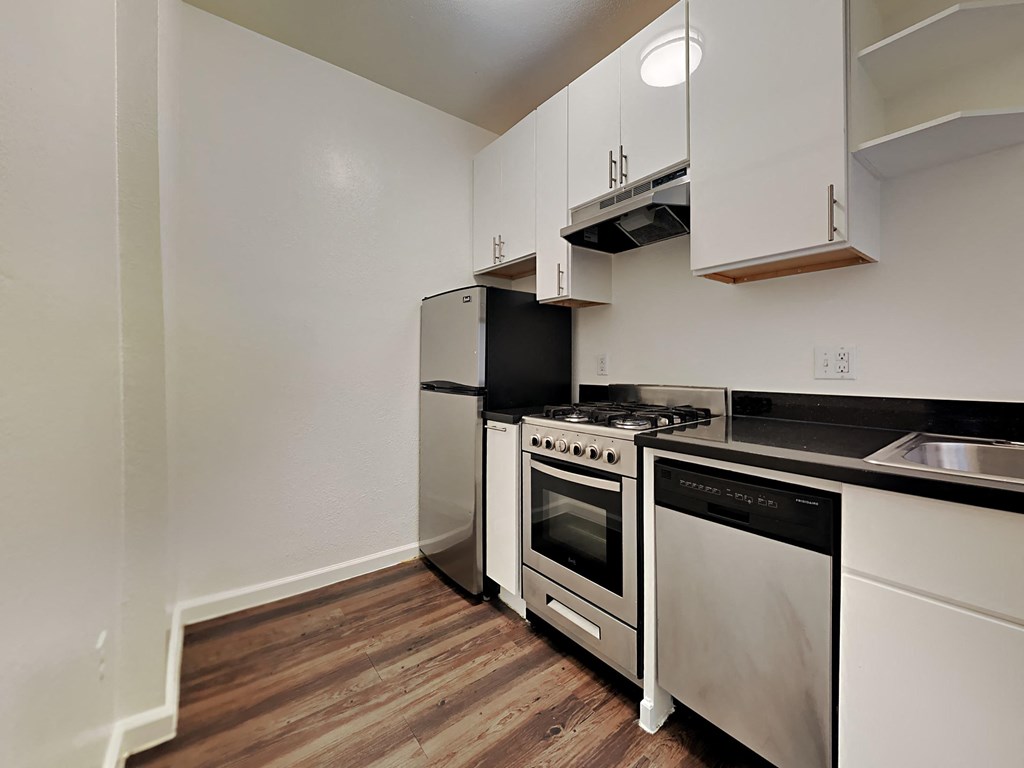 a kitchen with stainless steel appliances and white cabinets