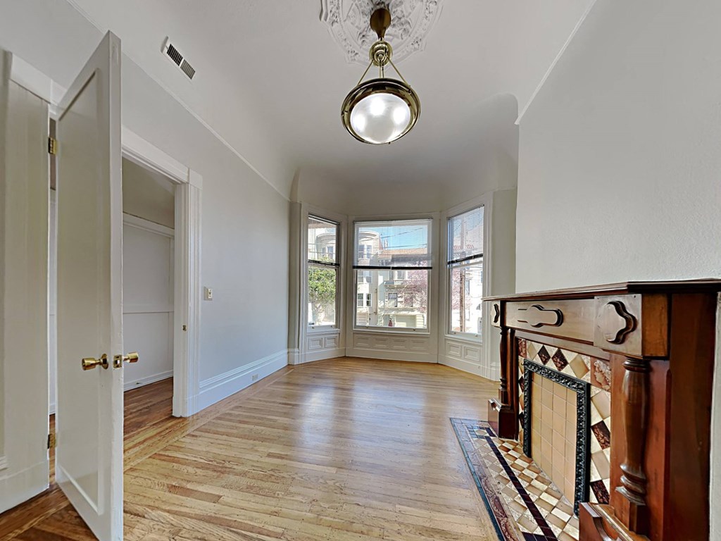 a living room with a fireplace and a door to a hallway