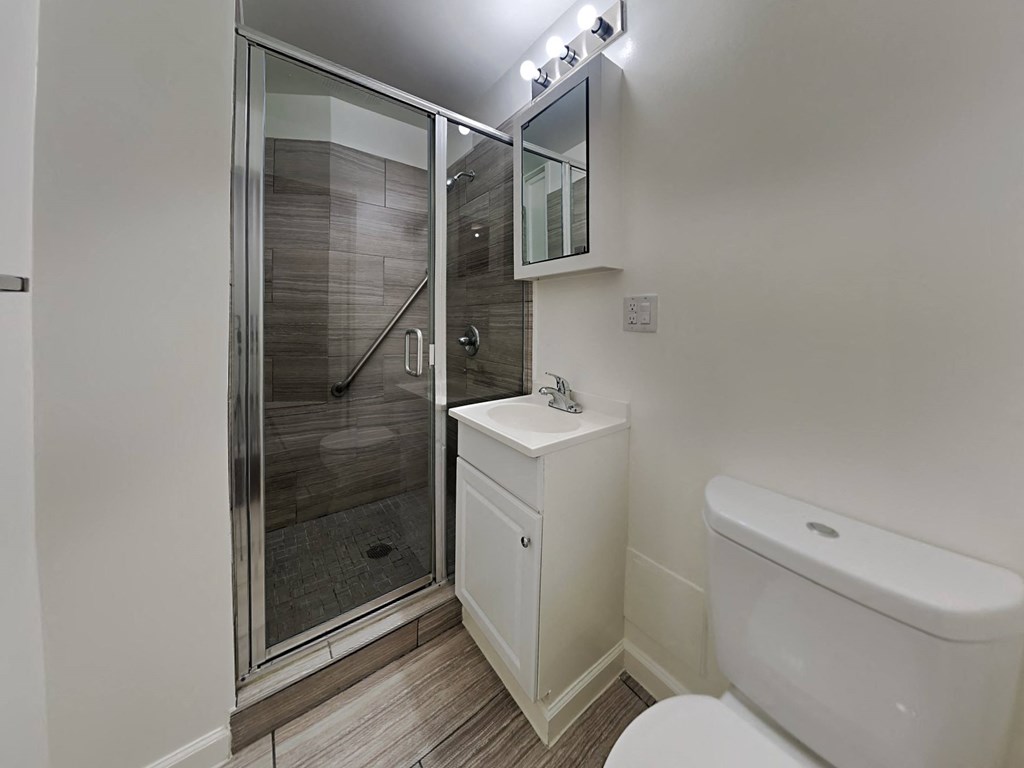 a bathroom with a toilet sink and a shower