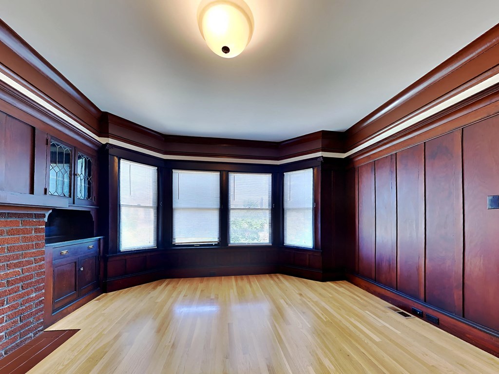 an empty living room with wood floors and windows