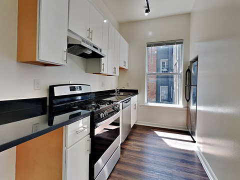 a kitchen with stainless steel appliances and a window