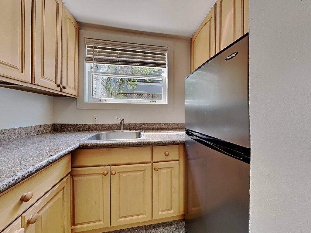 a kitchen with a sink and a refrigerator