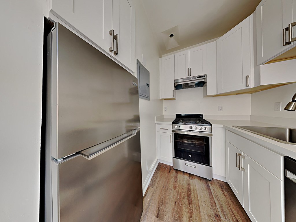 a kitchen with stainless steel appliances and white cabinets