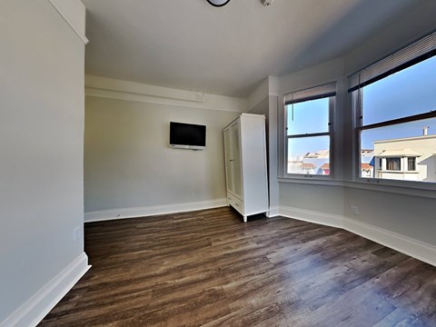 a living room with a window and a tv