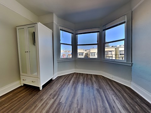 an empty room with windows and a closet