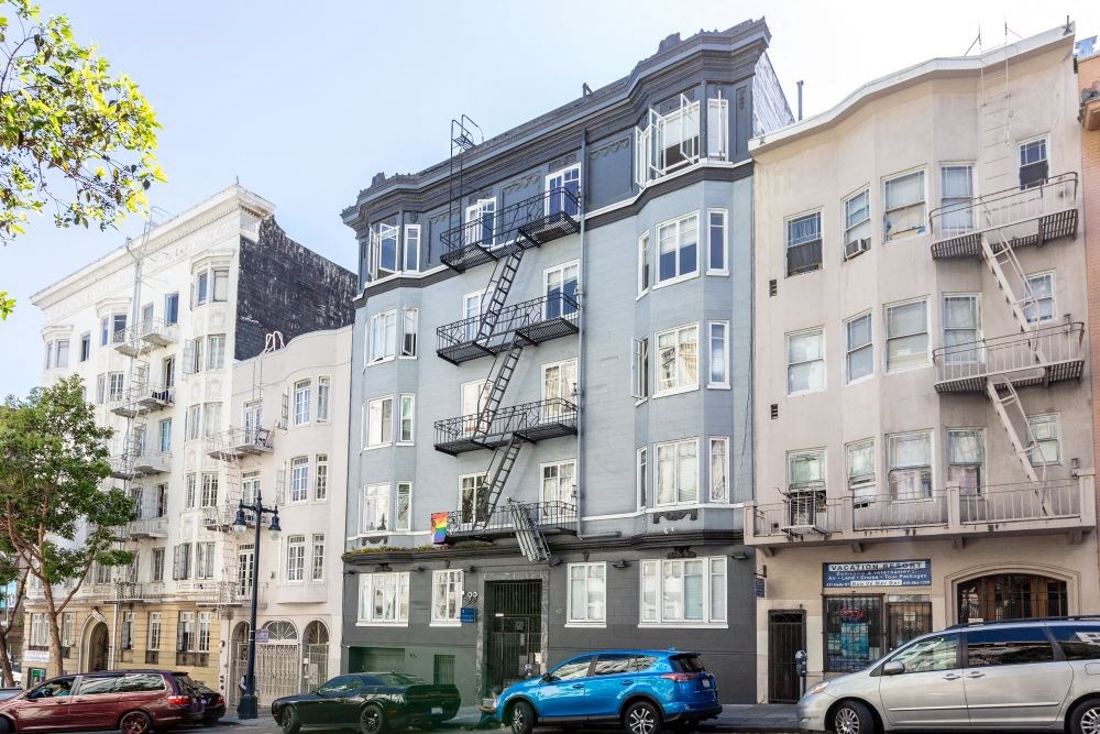 a building with two fire escapes on the side of a street