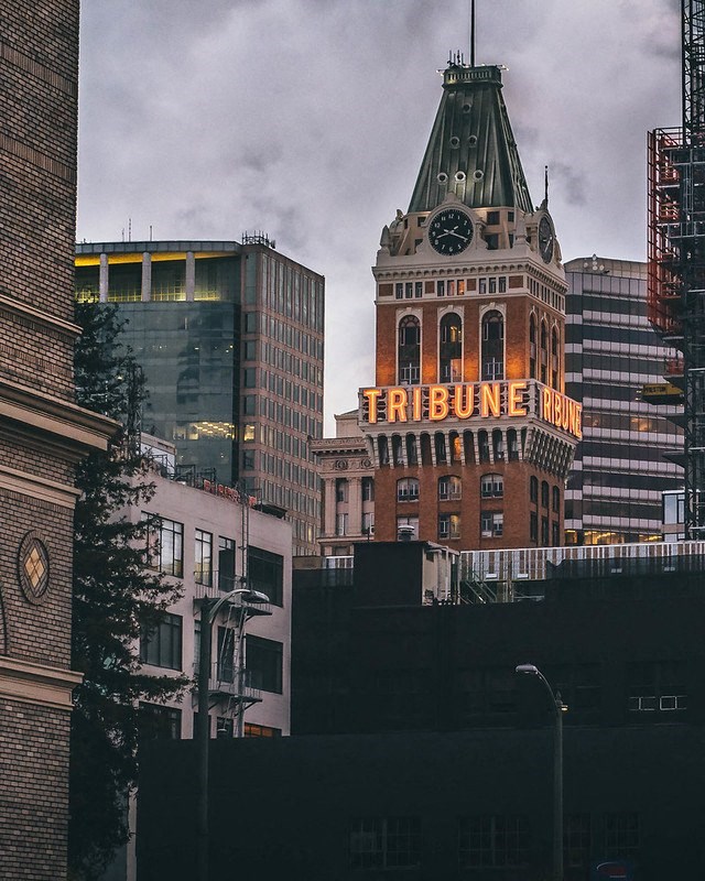 a large building with a clock tower in a city