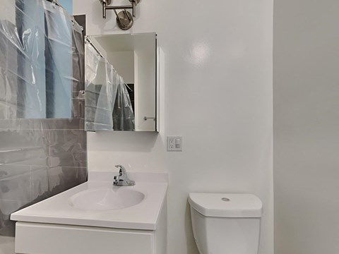 A white sink and toilet in a bathroom.