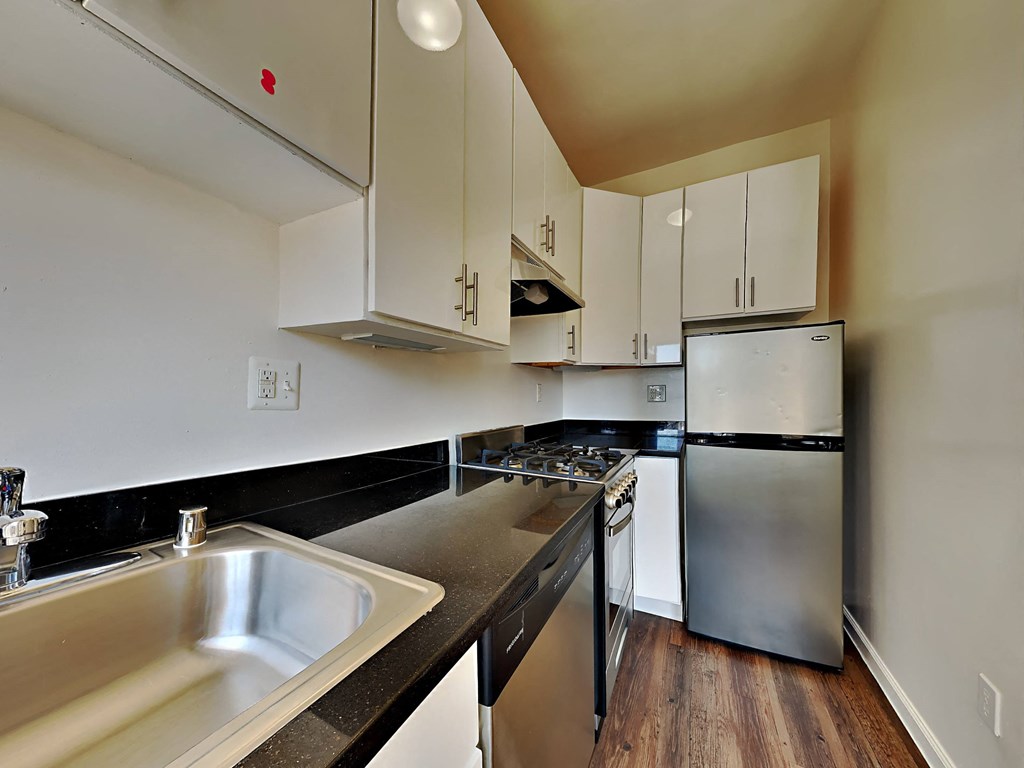 a kitchen with stainless steel appliances and white cabinets