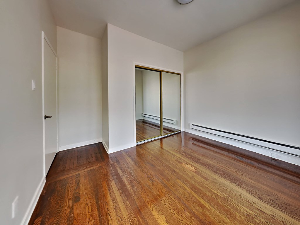 a living room with wood floors and white walls