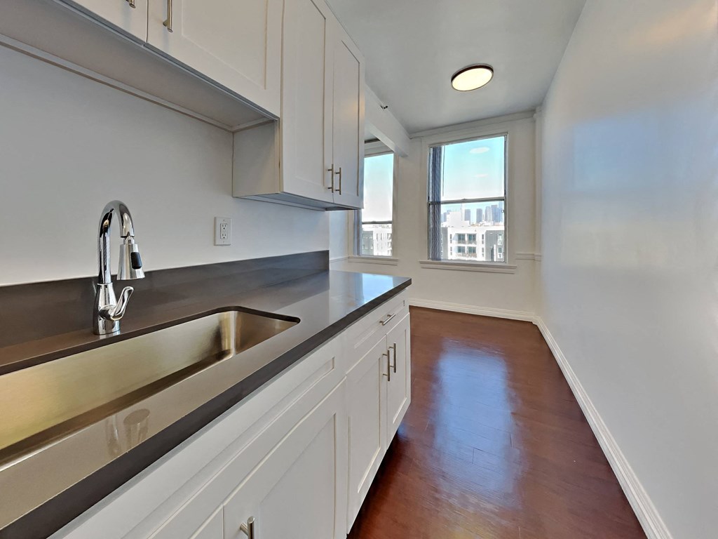 an empty kitchen with a sink and a window