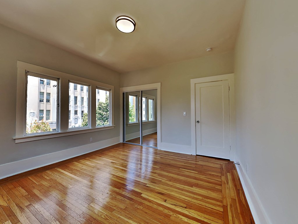 a living room with a hard wood floor and windows