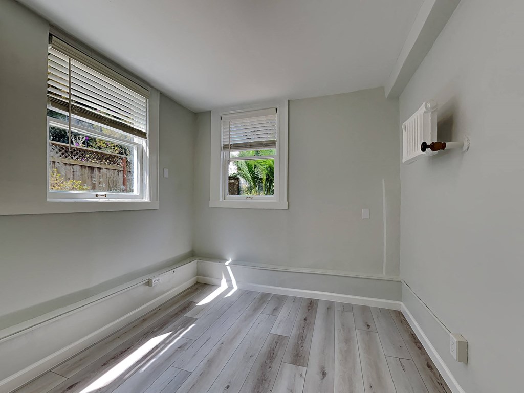 a room with wooden floors and a window