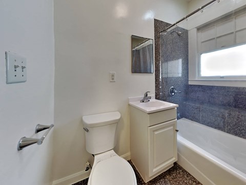 a bathroom with a toilet and a sink and a bath tub