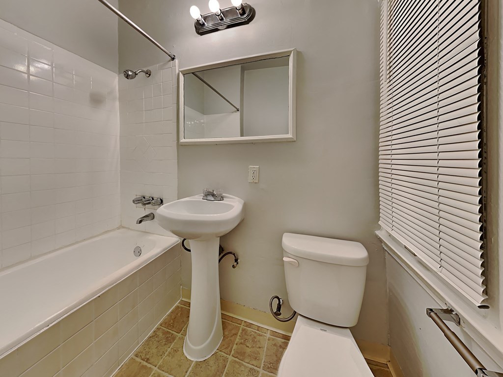 a bathroom with a sink toilet and a tub