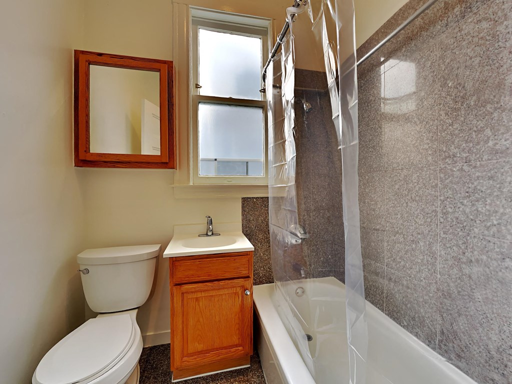 a bathroom with a toilet and a tub and a sink