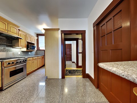 a kitchen with granite counter tops and wooden cabinets