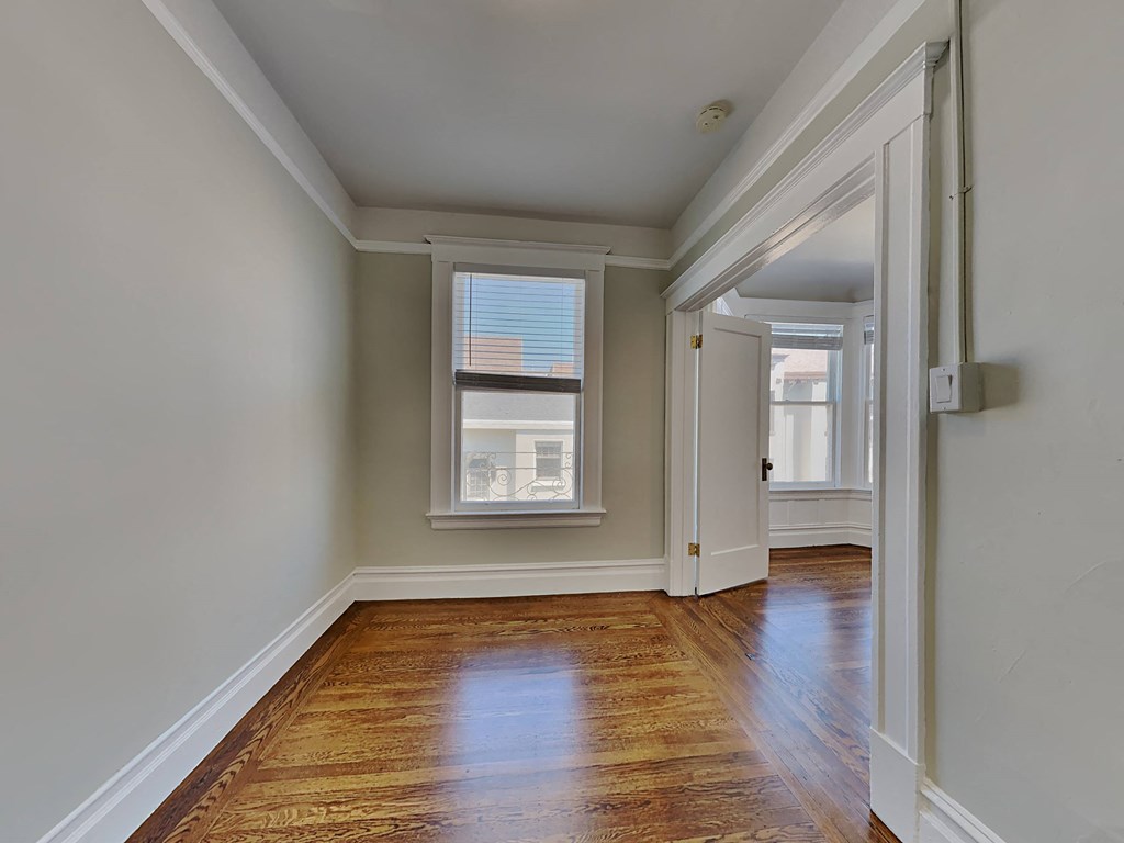 a living room with wood floors and a window