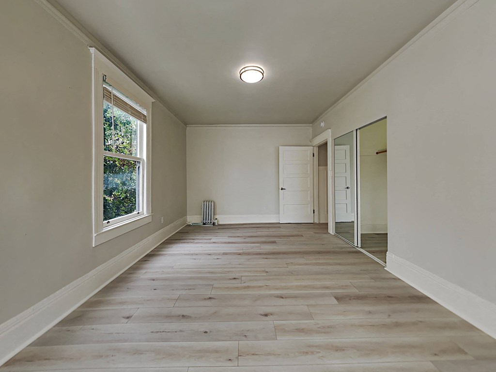 a empty room with a window and a door