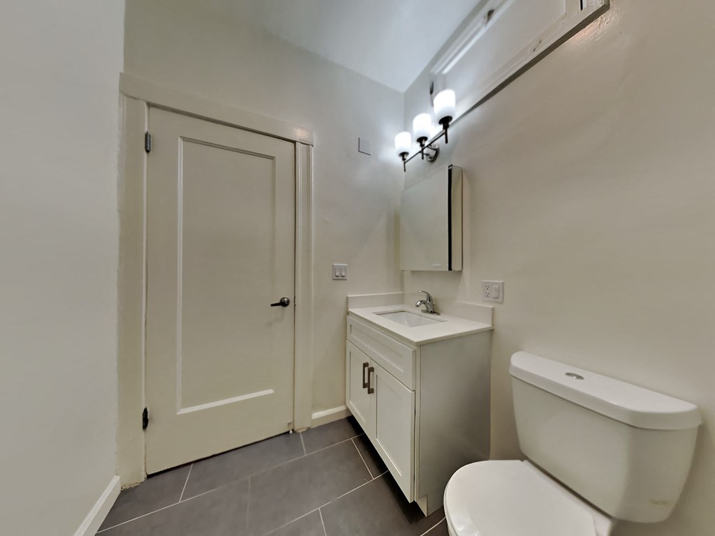 a bathroom with a toilet sink and a door