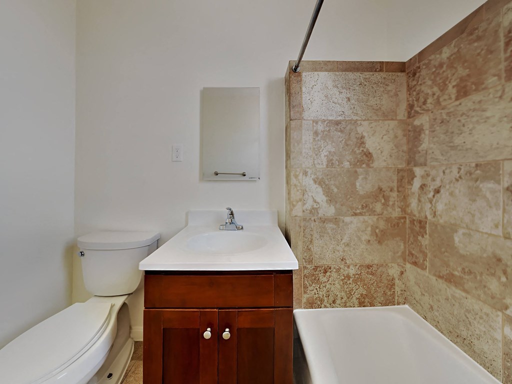 a bathroom with a toilet sink and bath tub