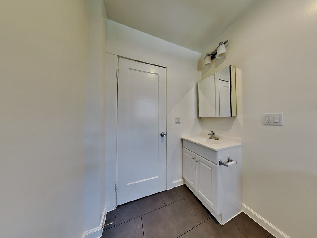 a bathroom with a sink and a white door