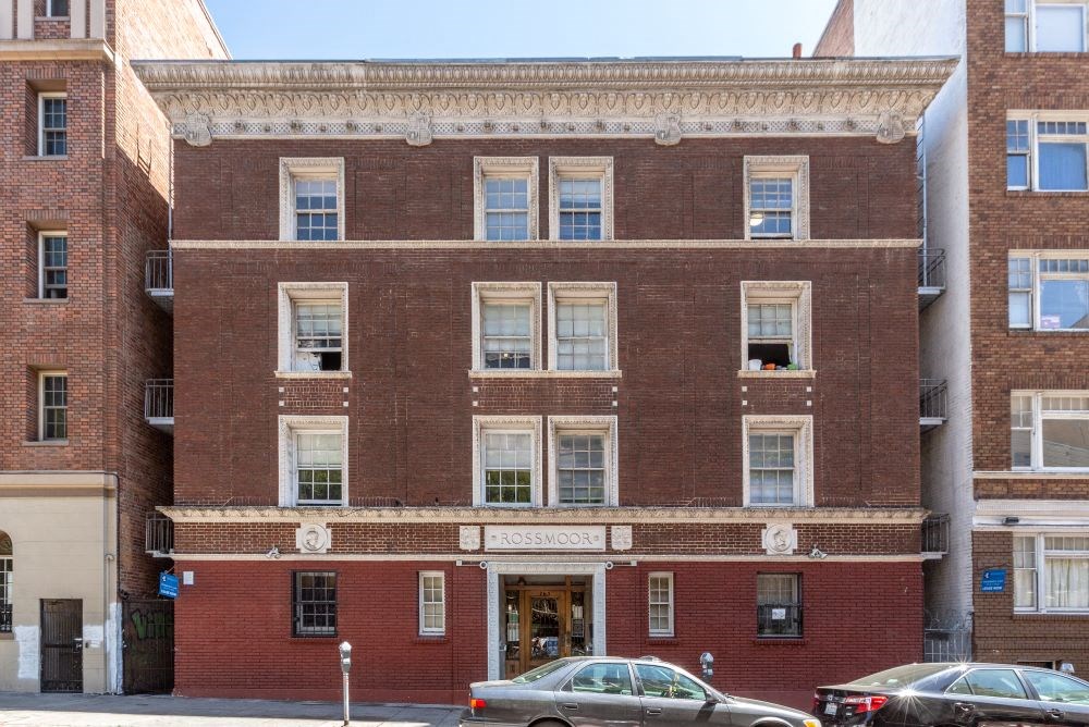 a large brick building with cars parked in front of it