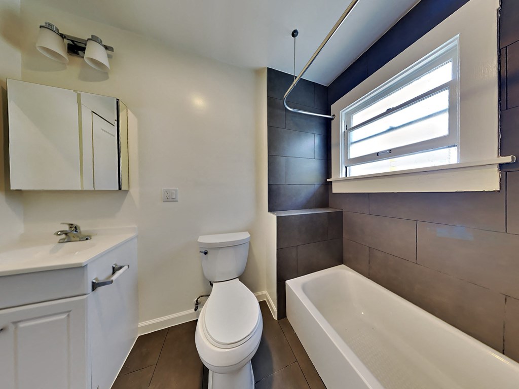 an empty bathroom with a toilet and a bath tub