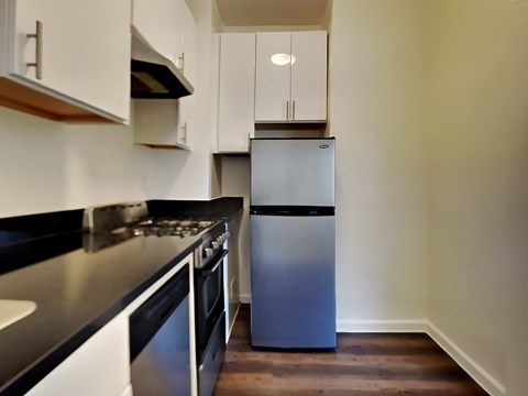 a kitchen with a stainless steel refrigerator and a stove