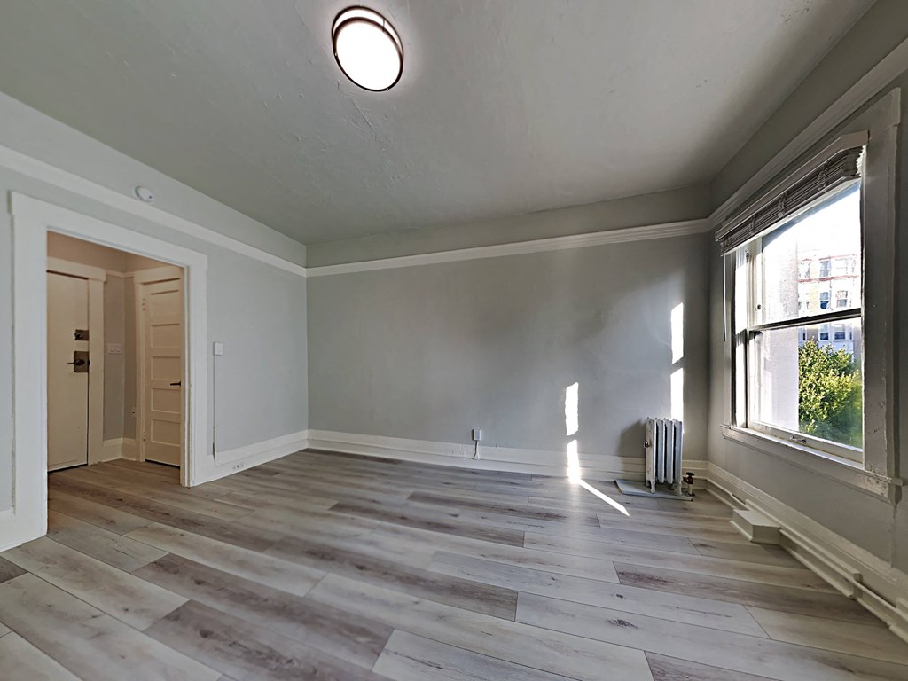 a living room with grey walls and a large window