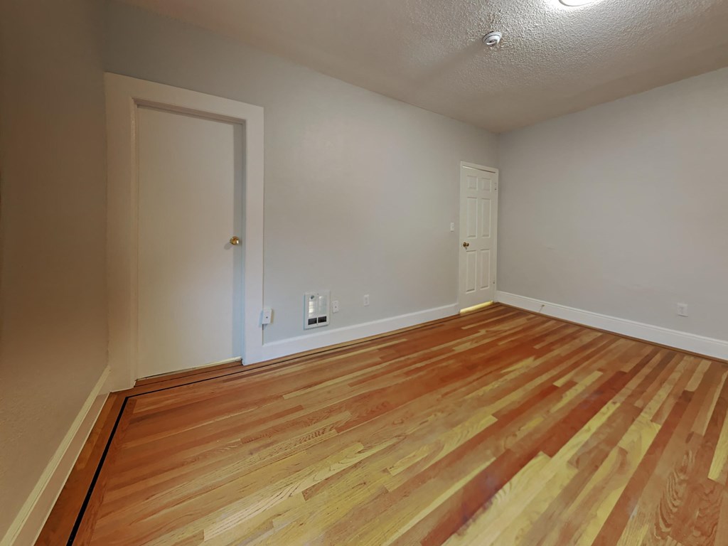 a living room with wood flooring and a door